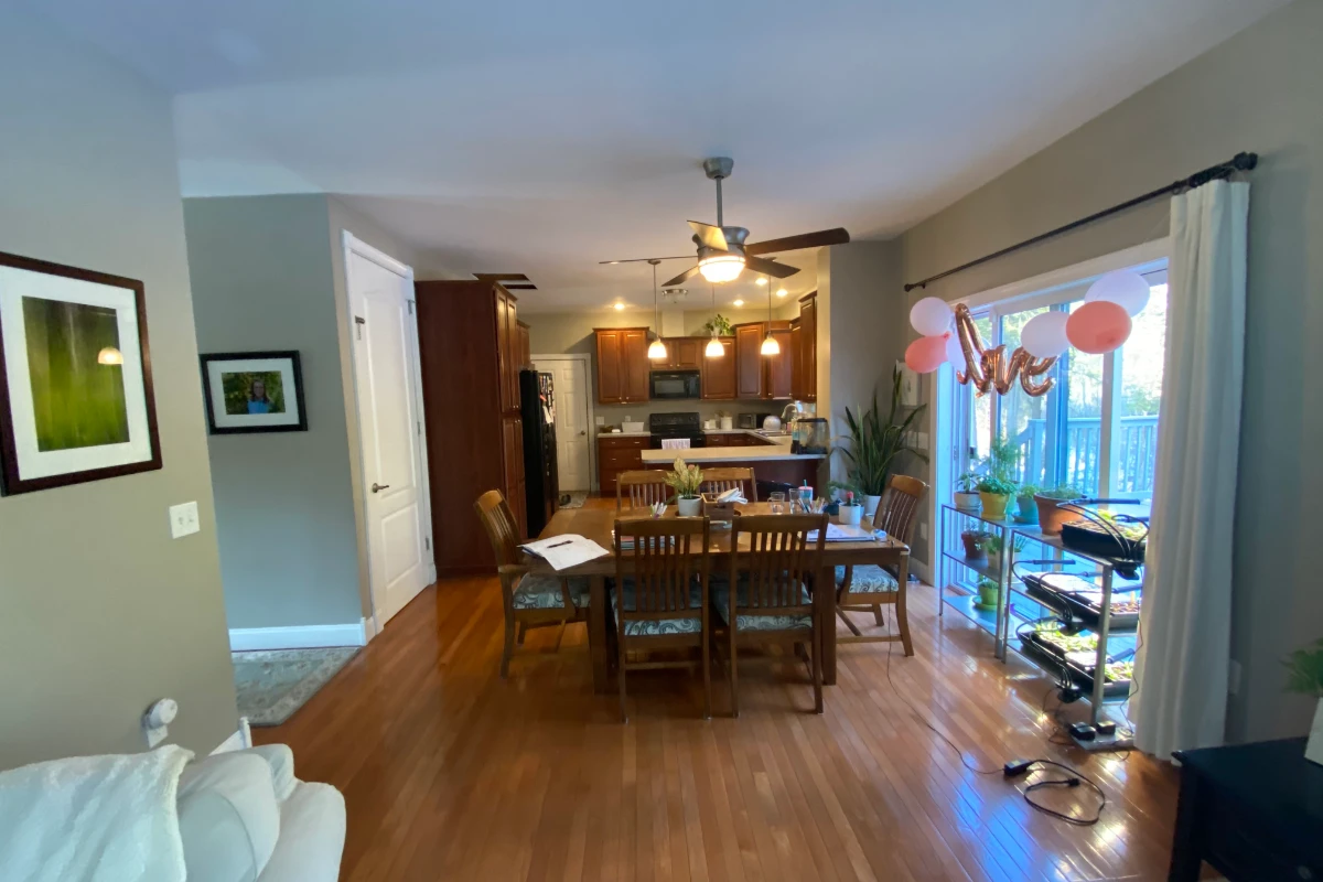 The first floor before, with dark wood cabinets and the dining table in a separate room