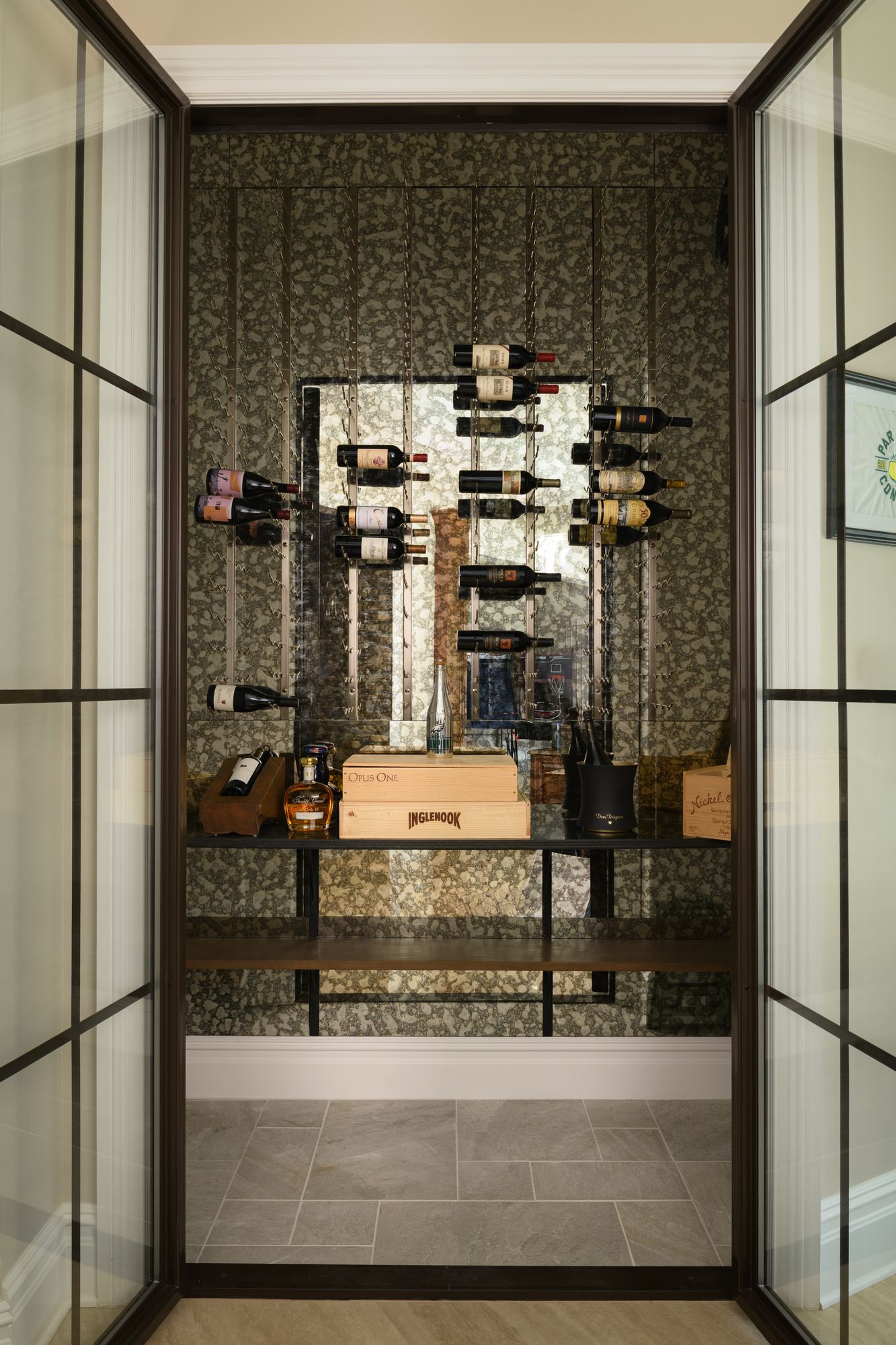 Glass-enclosed wine room with wall-mounted bottle racks
