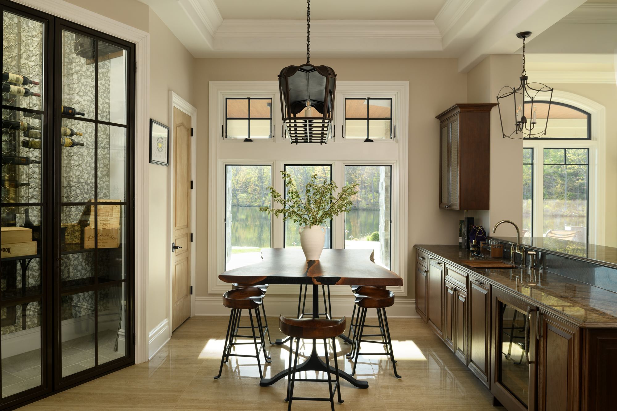 Tasting room with a glass wine wall, a high-top table and a wet bar