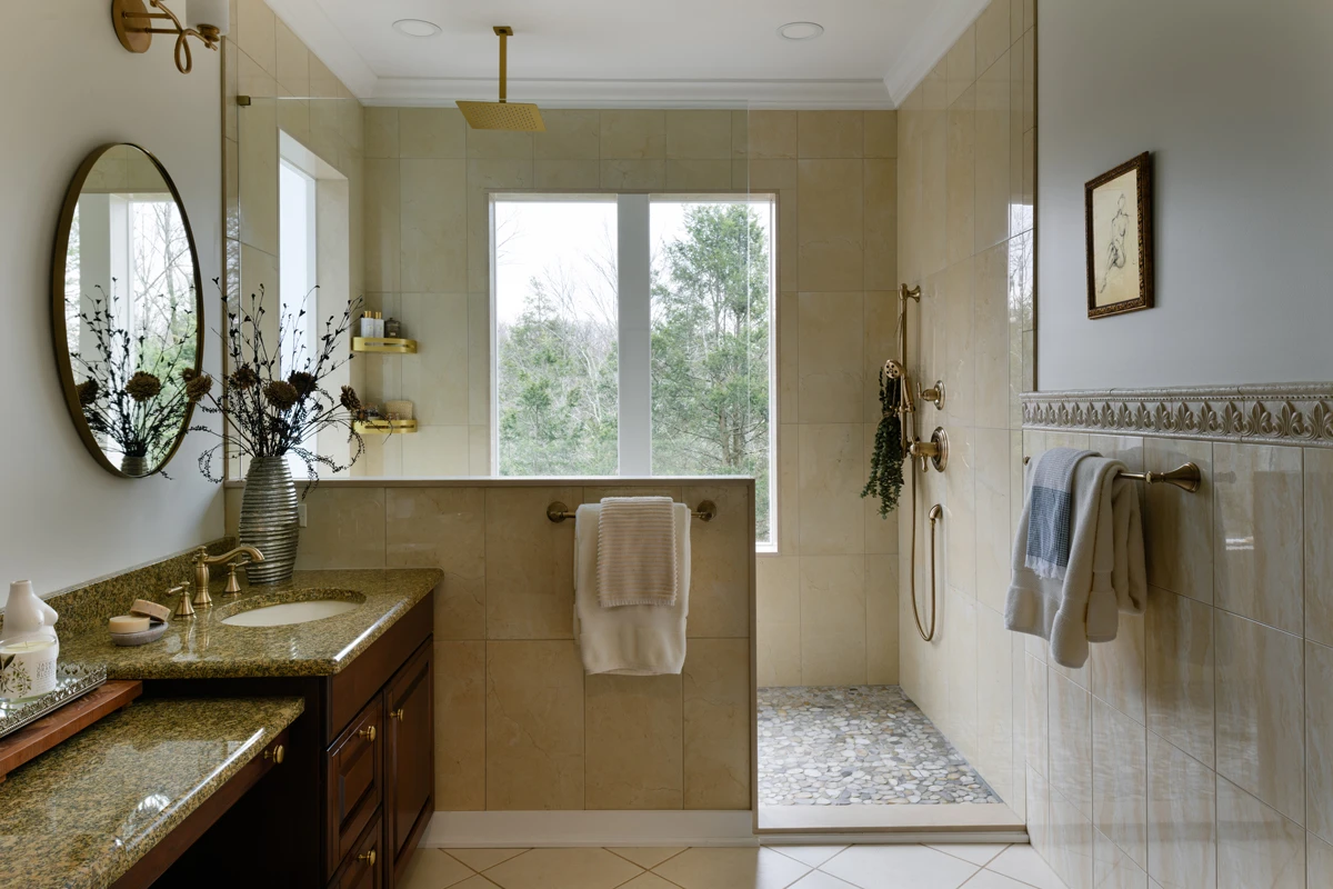 A bright bathroom with a walk-in shower and lights either side of the mirror