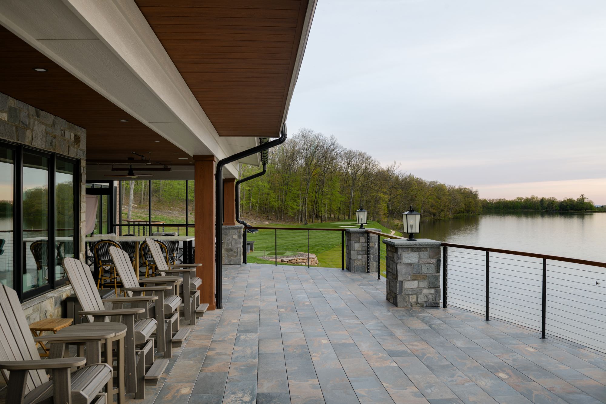 Covered patio with rocking chairs overlooking the lake