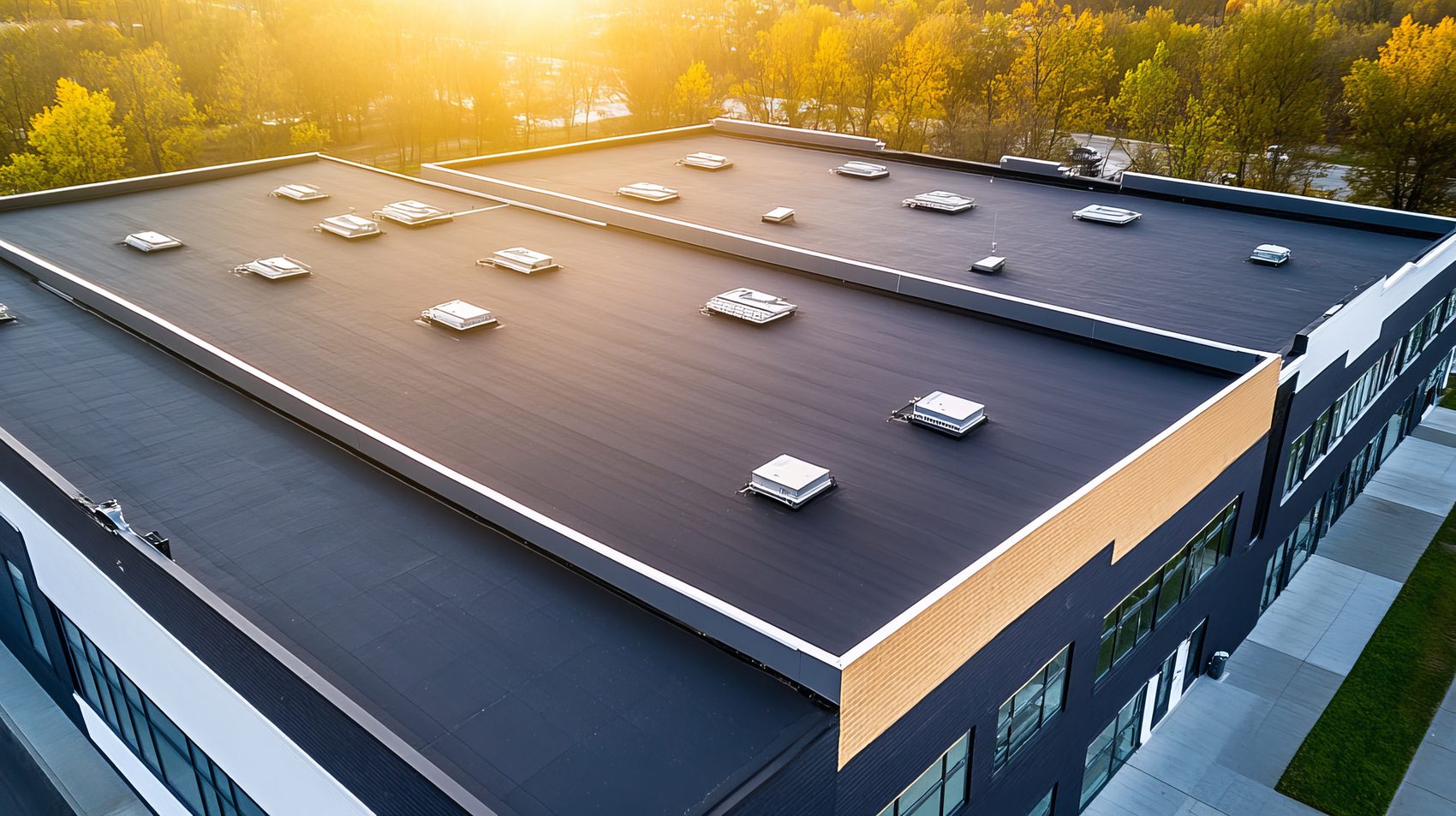 A commercial building with a new black membrane roof and skylights