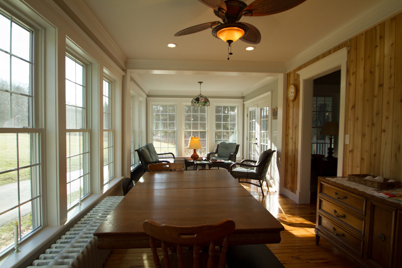 A bright sunroom addition with windows on three sides