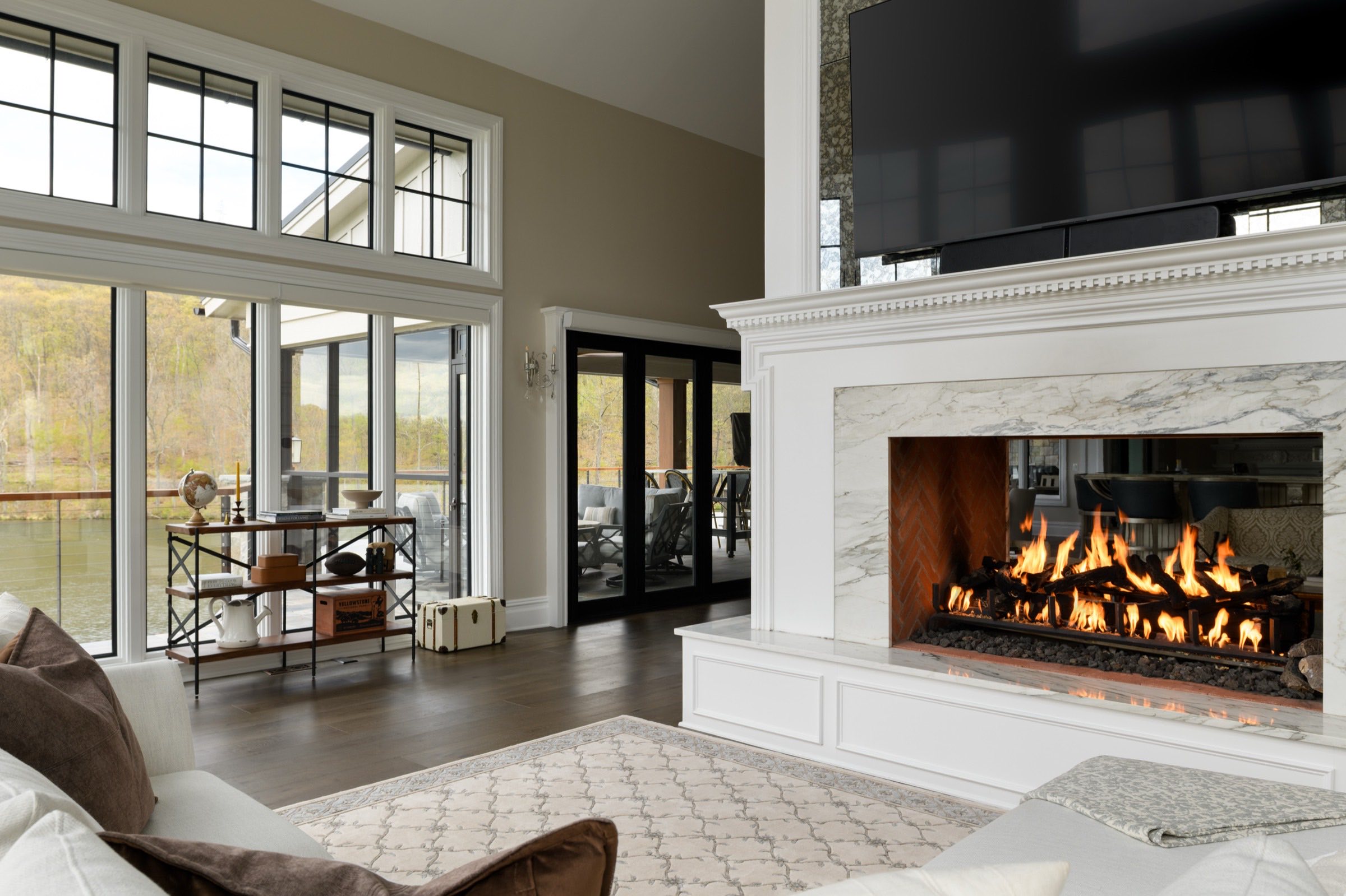 A finished great room with a marble fireplace wall