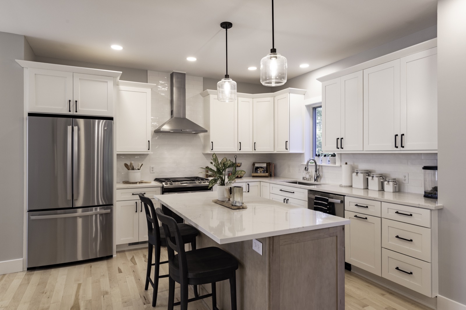 Whole-house remodel: open kitchen with blue-gray cabinetry and marble island