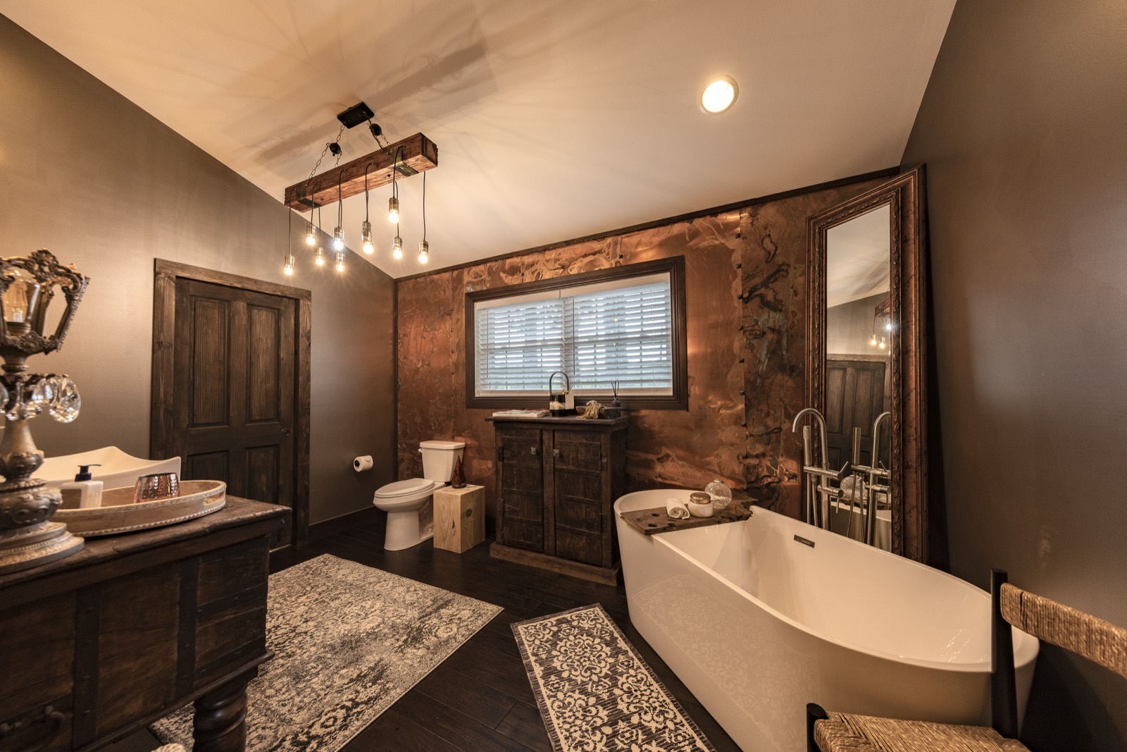 Remodeled bathroom with freestanding tub and copper accent wall