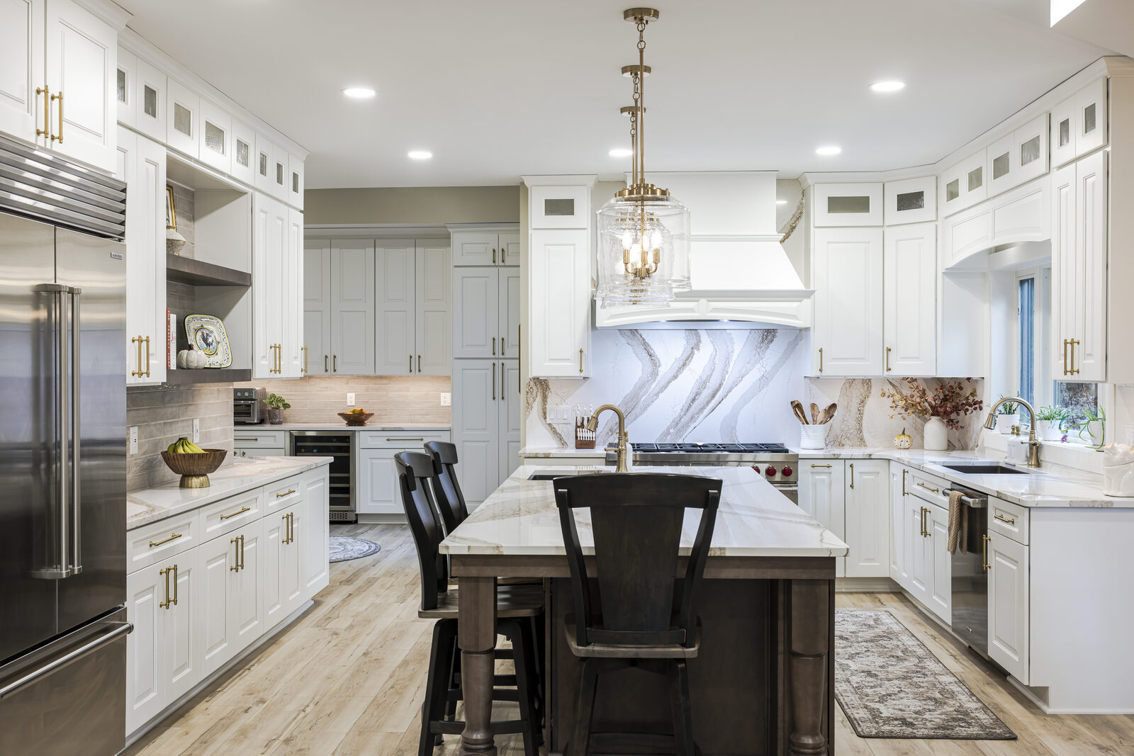 Kitchen with painted cabinetry and marble backsplash